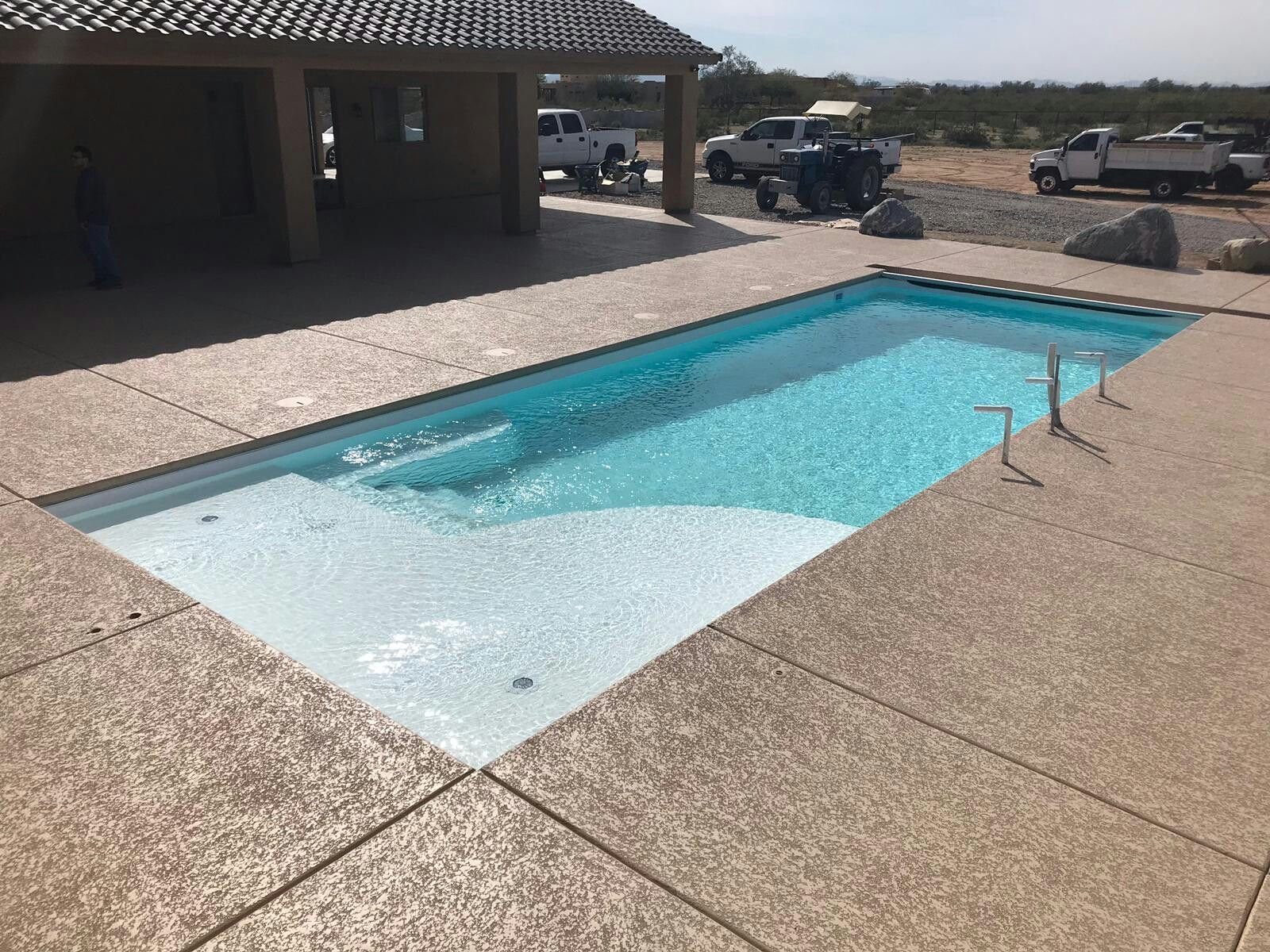 Freshly opened fiberglass pool with crystal-clear Sully Blue water