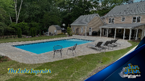 Lake Superior pool from San Juan with chairs on the pool patio and a house in the background on the right side